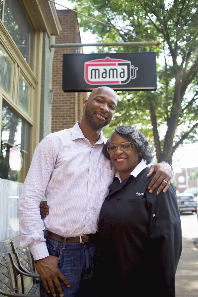 Mama and Lester Johnson in front of Mama J's restaurant