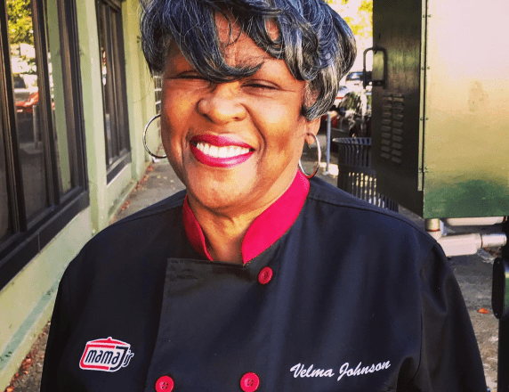 Velma “Mama J” Johnson portrait in front of Mama J's Southern Food Restaurant
