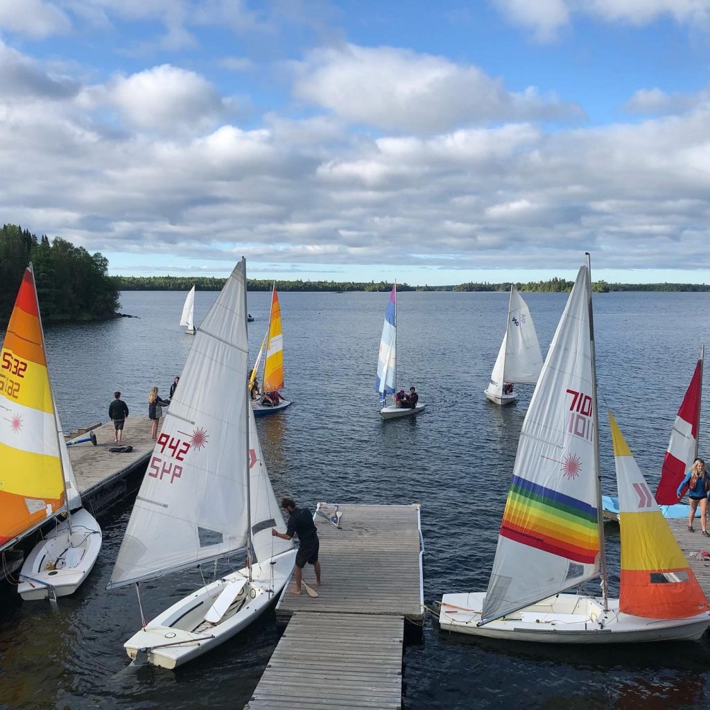 Campers sailing on a lake close to Pioneer Camp Manitoba