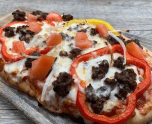 crumbled beef patty flatbread with peppers, onions and melted cheese