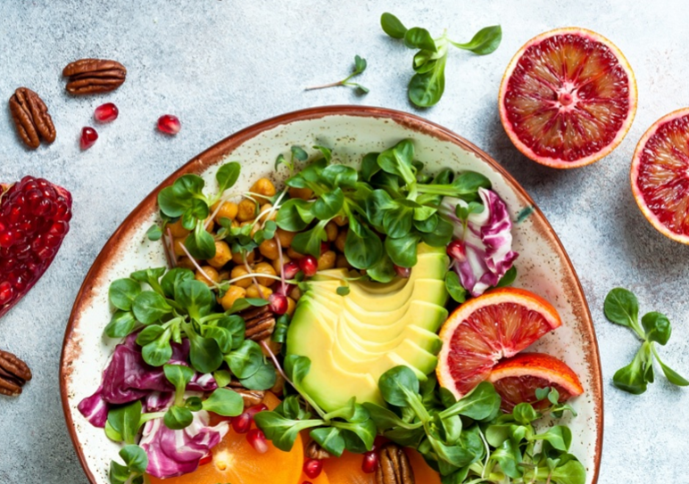 Colorful salad with oranges and greens, a refreshing and nutritious choice.