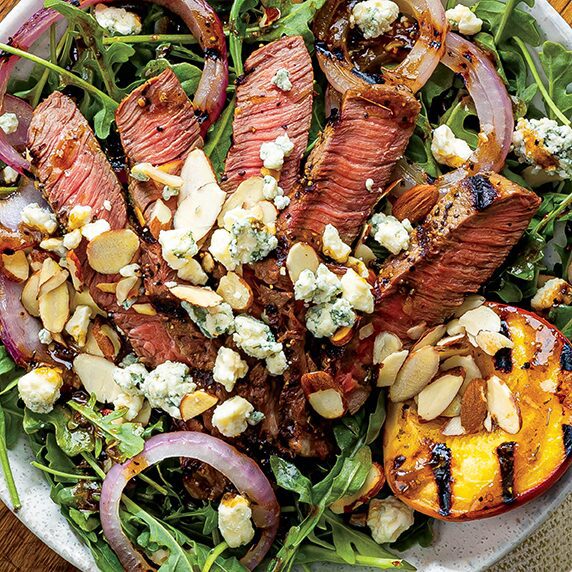 Delicious grilled steak served with peaches and blue cheese, a perfect combination